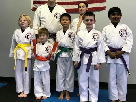 a group of people in karate uniforms