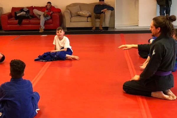 a person and a group of children sitting on the floor