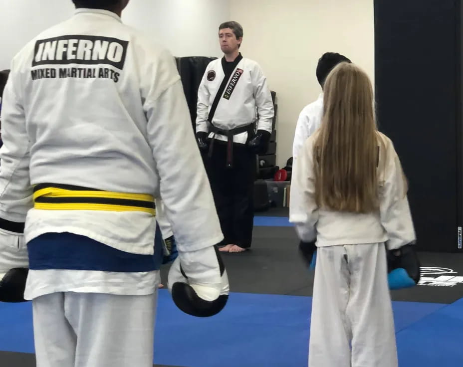 a group of people in white karate uniforms