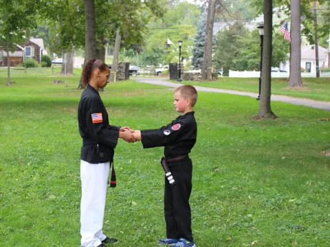 a person shaking hands with a boy