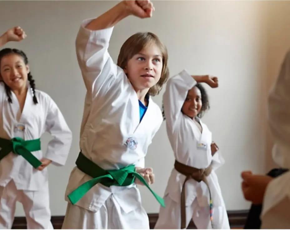 a group of women in white karate uniforms