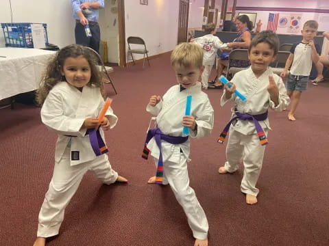 a group of children in karate uniforms