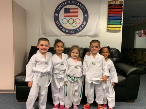 a group of children in karate uniforms