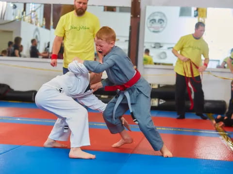 a boy and a man in a karate uniform