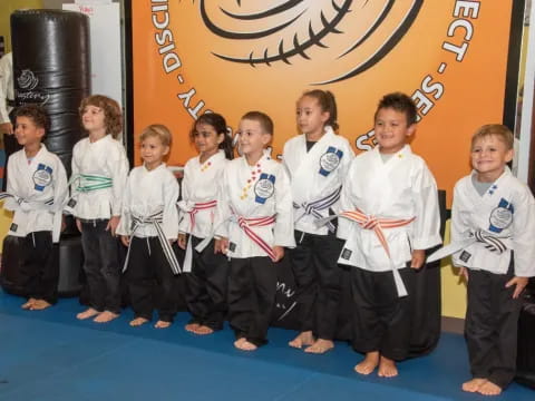 a group of children in karate uniforms