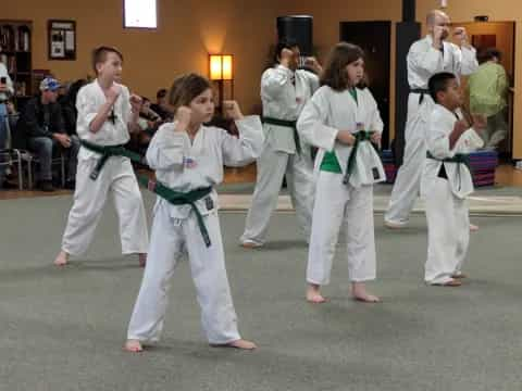 a group of people in karate uniforms