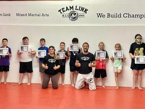 a group of people holding certificates