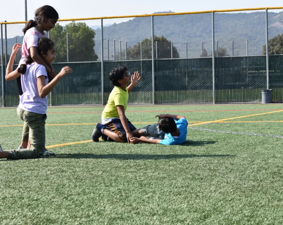 a group of kids playing on a field