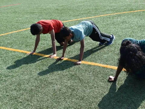 a group of people bent over on a field