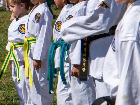 a group of people in white karate uniforms