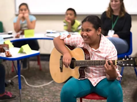 a boy playing a guitar