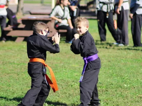 a couple of boys playing with a toy sword