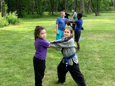 a group of kids playing in the grass