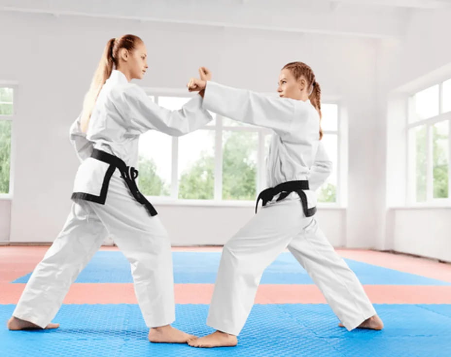 a couple of women practicing karate