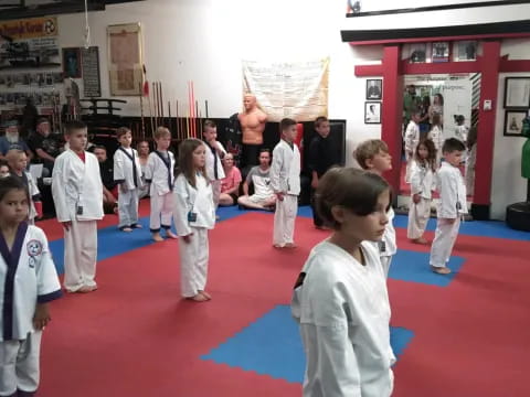 a group of children in karate uniforms