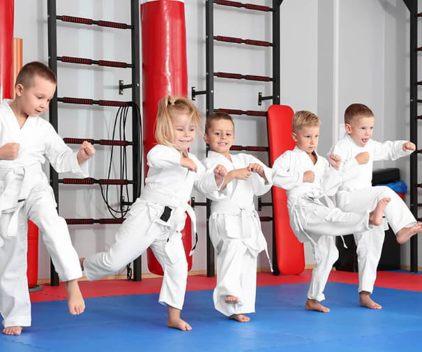 a group of children in karate uniforms