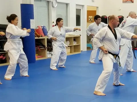 a group of people in karate uniforms