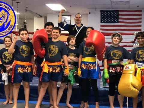 a group of people posing for a photo with boxing gloves