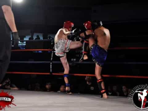 a man punching another man in a boxing ring