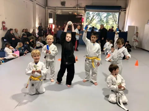 a group of children in karate uniforms