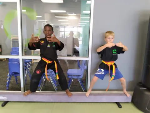 two boys in martial arts uniforms