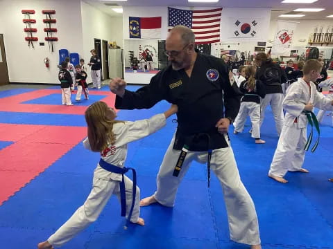 a person and a girl practicing karate