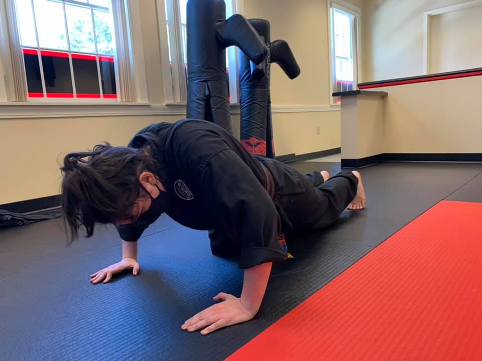 a person doing a handstand on a mat