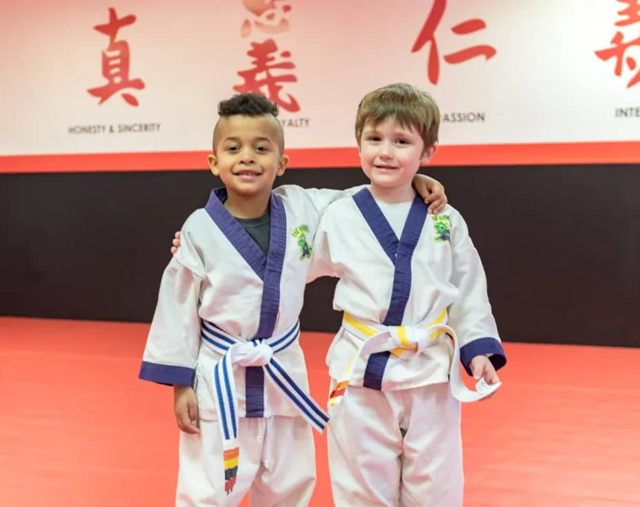 a couple of boys wearing medals