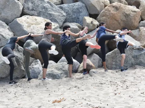 a group of people posing for a picture on a beach