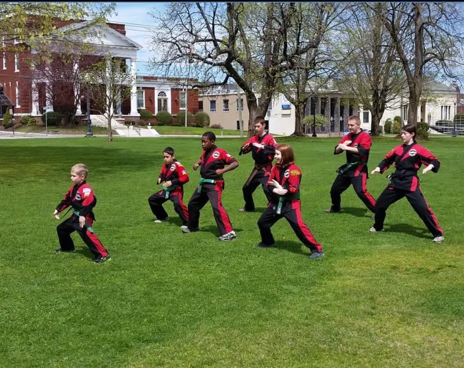 a group of people in uniform running on a field