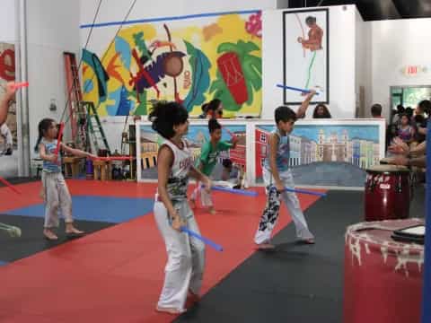 a group of kids playing martial arts