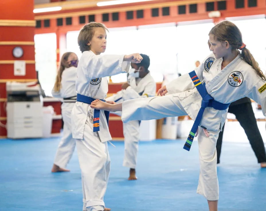 a group of girls in karate uniforms