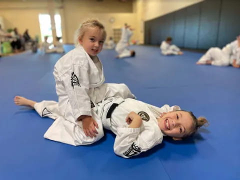 a boy and a girl in karate uniforms