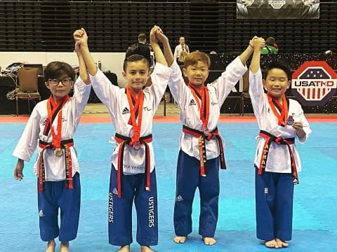 a group of boys wearing medals and posing for a photo