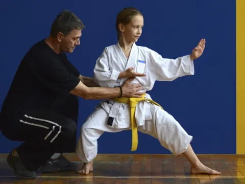 a man and a woman in karate uniforms