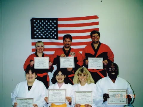 a group of people holding certificates