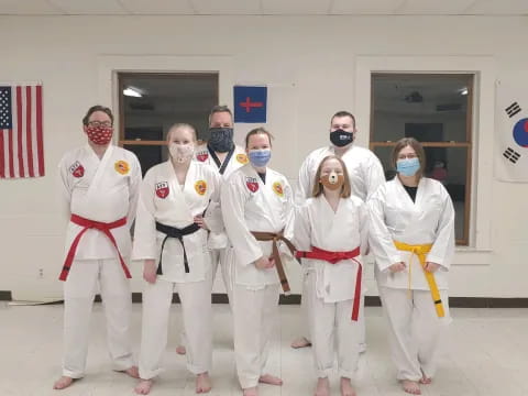 a group of people in white karate uniforms