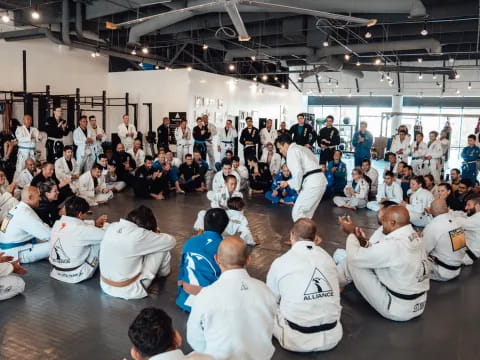 a group of people in white karate uniforms