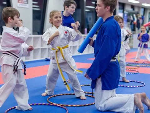 a group of children in karate uniforms