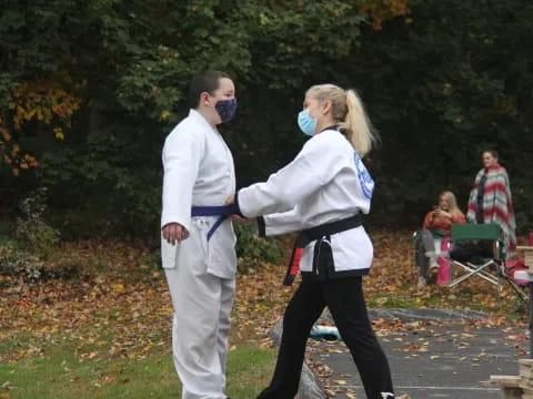 a man and woman wearing masks