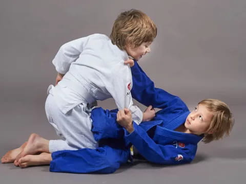 a boy and a girl in karate uniforms