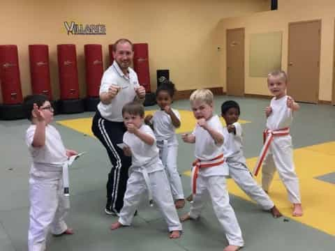 a group of kids in karate uniforms