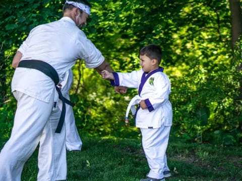 a man and a boy in karate uniforms