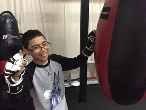 a boy holding a boxing glove