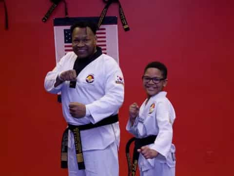 a man and a boy in karate uniforms