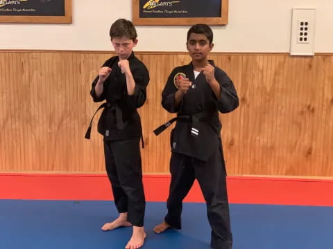 two boys in black karate uniforms