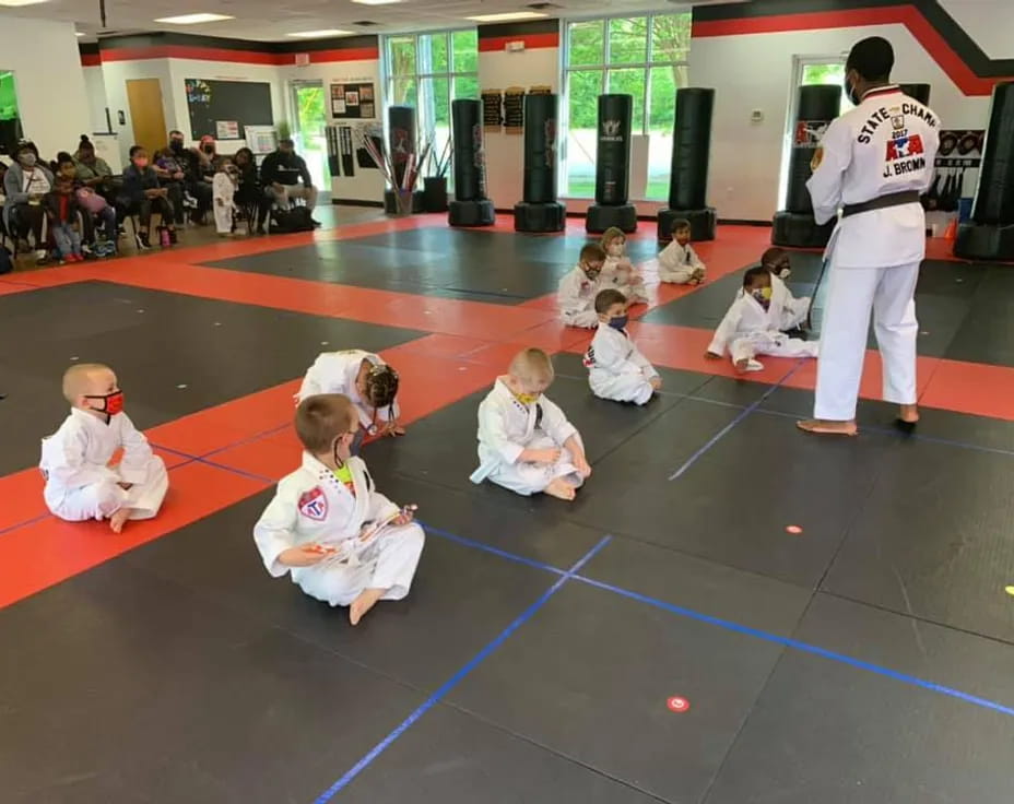 a group of children in karate uniforms