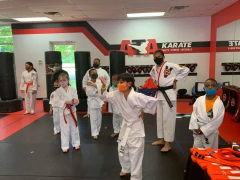 a group of people in white karate uniforms