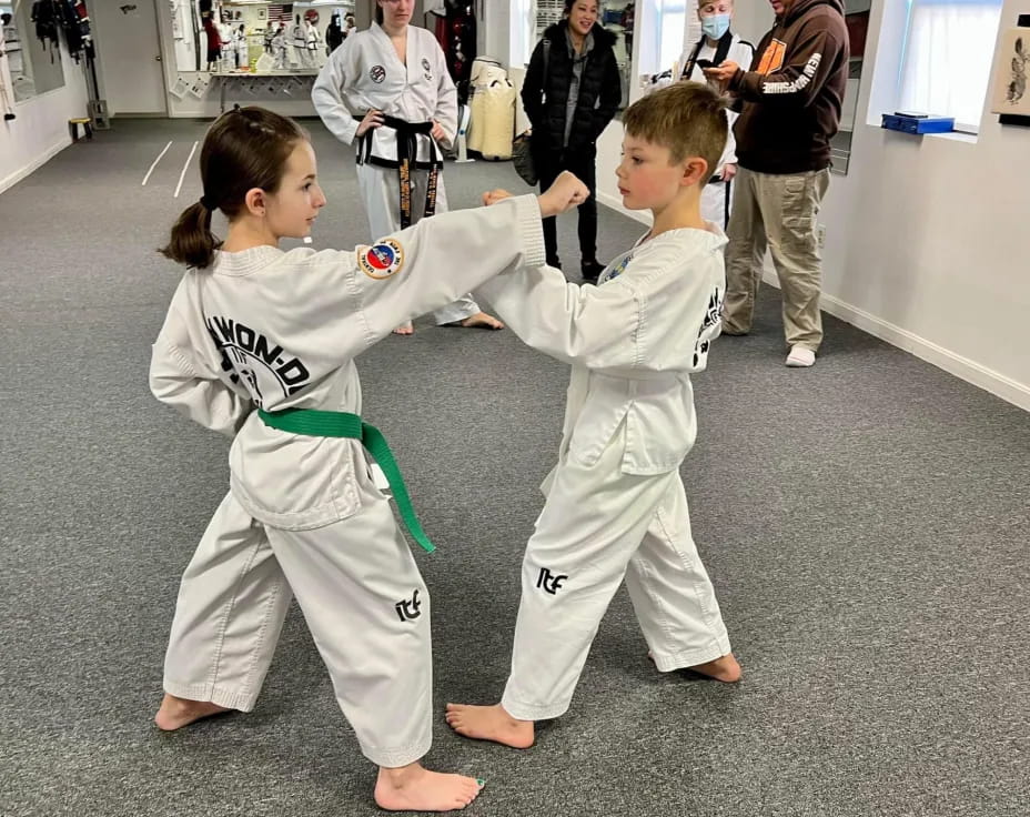 a couple of children in karate uniforms