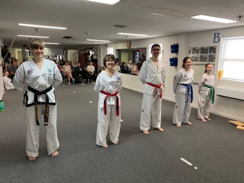 a group of people in karate uniforms